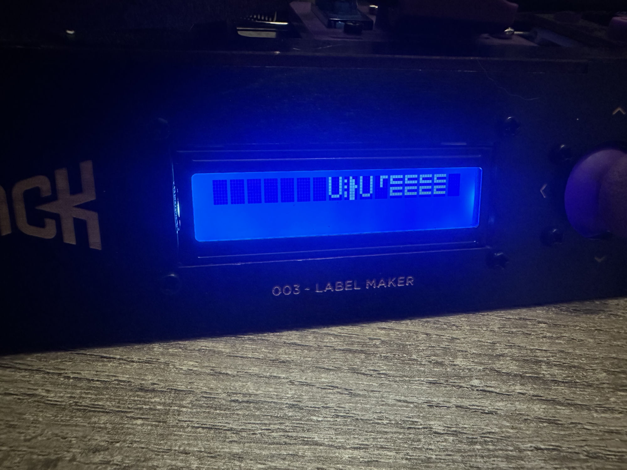 The 16x2 LCD lit up blue, showing rows of solid blocks and scrambled
symbols instead of readable text.